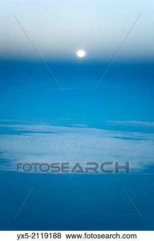 Stock Photo - Aerial view of the moon and clouds from an airplane.. Fotosearch