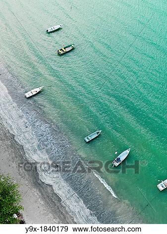 Stock Photo - Aerial view of the river shores of Johor featuring boats and piers. Fotosearch