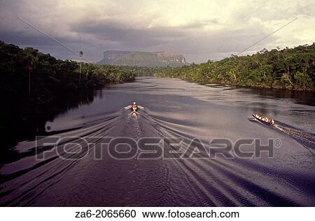 Aerial view of tourist boats going up Carrao river showing tepuis in the bakground. Canaima National Park, Bolivar State, Southern Venezuela. View Large Photo Image Stock Image - Aerial view of tourist boats going up Carrao river showing tepuis in the bakground. Canaima National Park, Bolivar State, Southern Venezuela.. Fotosearch