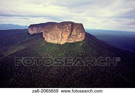 Aerial view of upper escarpment of Huachamakari-tepuy showing the raiforest covered talus slopes. Duida-Marawaka-Huachamakari National Park. Amazonas State, Southern Venezuela. View Large Photo Image Stock Photo - Aerial view of upper escarpment of Huachamakari-tepuy showing the raiforest covered talus slopes. Duida-Marawaka-Huachamakari National Park. Amazonas State, Southern Venezuela.. Fotosearch