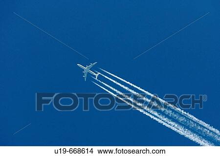 Aeroplane and vapour trail View Large Photo Image Picture - Aeroplane and vapour trail. Fotosearch