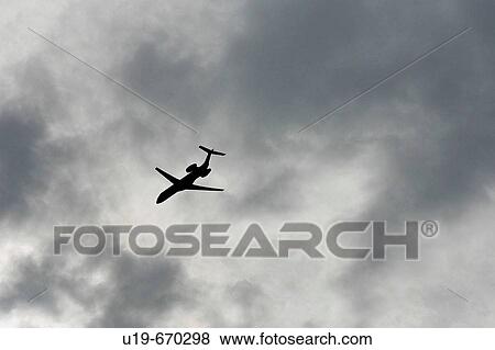 Aeroplane in a stormy sky View Large Photo Image Stock Photo - Aeroplane in a stormy sky. Fotosearch