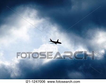 Aeroplane in a stormy sky View Large Photo Image Stock Photograph - Aeroplane in a stormy sky. Fotosearch