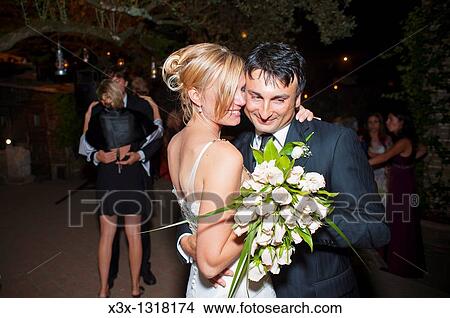 Affectionate bride and groom dancing at wedding View Large Photo Image Picture - Affectionate bride and groom dancing at wedding. Fotosearch