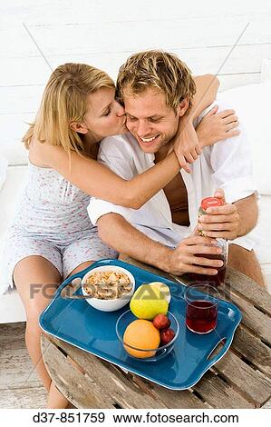 Affectionate couple at home having breakfast View Large Photo Image Stock Photo - Affectionate couple at home having breakfast. Fotosearch