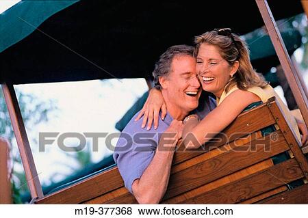 Stock Photo - affectionate couple on a swing. Fotosearch