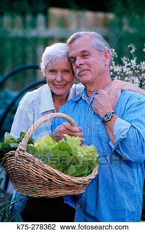 Affectionate senior couple with basket of lettuce View Large Photo Image Stock Image - Affectionate senior couple with basket of lettuce. Fotosearch