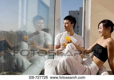 Stock Photograph - affectionate young couple in urban apartment. Fotosearch