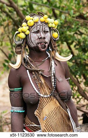 Africa, Ethiopia, Debub Omo Zone, Mursi tribesmen A nomadic cattle herder ethnic group located in Southern Ethiopia, close to the Sudanese border Woman with clay lip disc as body ornaments View Large Photo Image Stock Image - Africa, Ethiopia, Debub Omo Zone, Mursi tribesmen A nomadic cattle herder ethnic group located in Southern Ethiopia, close to the Sudanese border Woman with clay lip disc as body ornaments. Fotosearch