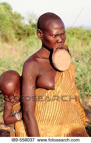 Africa, Ethiopia, Omo river region, young Mursi with a traditional lip plate View Large Photo Image Stock Photo - Africa, Ethiopia, Omo river region, young Mursi with a traditional lip plate. Fotosearch