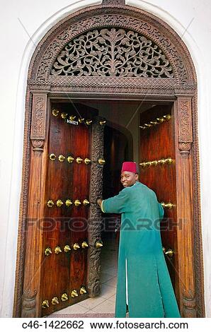 Stock Image - Africa House Hotel, Traditional carved wooden door in Stone Town Zanzibar Island Tanzania.. Fotosearch