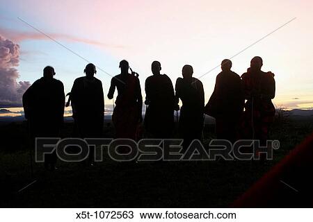 Africa, Tanzania, Silhouette of a group of Maasai men at sunset An ethnic group of semi-nomadic people February 2006 View Large Photo Image Stock Image - Africa, Tanzania, Silhouette of a group of Maasai men at sunset An ethnic group of semi-nomadic people February 2006. Fotosearch