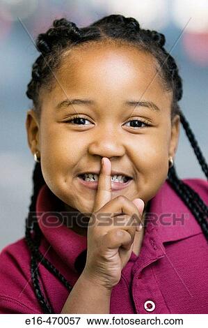 Stock Photo - African Ameican girl making quiet signal. Fotosearch