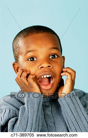 Stock Photography - African-american boy surprised. Fotosearch