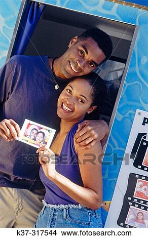 African american couple at photo booth in fun fair View Large Photo Image Picture - African american couple at photo booth in fun fair. Fotosearch