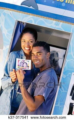 African american couple at photo booth in fun fair View Large Photo Image Stock Image - African american couple at photo booth in fun fair. Fotosearch