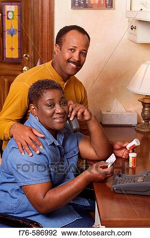 African American Couple discussing medications, calling in for prescription refill. View Large Photo Image Stock Image - African American Couple discussing medications, calling in for prescription refill.. Fotosearch