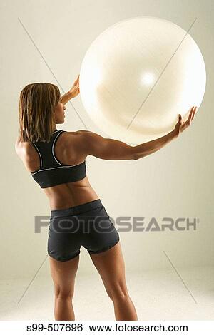Stock Photograph - African american female fitness model, action. Fotosearch