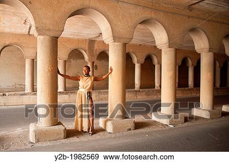African American female model wearing tan dress standing between columns of automobile tunnel in urban Memphis Tennessee USA. View Large Photo Image Stock Photo - African American female model wearing tan dress standing between columns of automobile tunnel in urban Memphis Tennessee USA.. Fotosearch