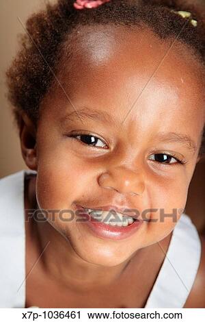 Stock Image - African American girl smiling. Fotosearch