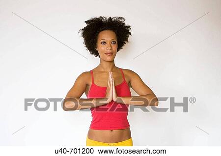 Stock Image - African American woman doing Yoga. Fotosearch