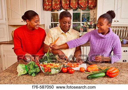 African American woman in kitchen, preparing vegetables with her daughter and granddaughter. View Large Photo Image Stock Image - African American woman in kitchen, preparing vegetables with her daughter and granddaughter.. Fotosearch