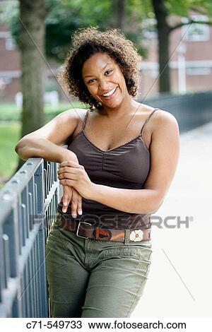 Stock Image - African-American woman smiling in camera. Fotosearch