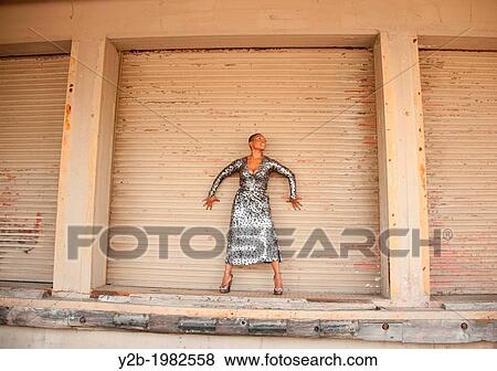 African American Woman Standing In Front Of Warehouse Door In Urban Memphis Tennessee Usa Stock Photo