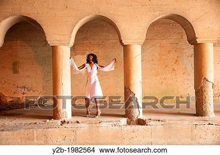 African American woman wearing white dress standing in front of columns of automobile tunnel in urban Memphis Tennessee USA. View Large Photo Image Picture - African American woman wearing white dress standing in front of columns of automobile tunnel in urban Memphis Tennessee USA.. Fotosearch