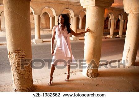 African American woman wearing white dress standing in front of columns of automobile tunnel in urban Memphis Tennessee USA. View Large Photo Image Stock Image - African American woman wearing white dress standing in front of columns of automobile tunnel in urban Memphis Tennessee USA.. Fotosearch