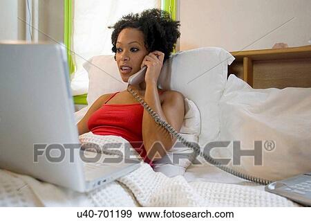 African American woman working from bed View Large Photo Image Stock Photo - African American woman working from bed. Fotosearch