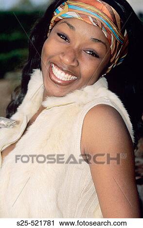 Stock Image - African Woman in Jeans and Fur Vest, Laguna Beach, California, MR #1067. Fotosearch