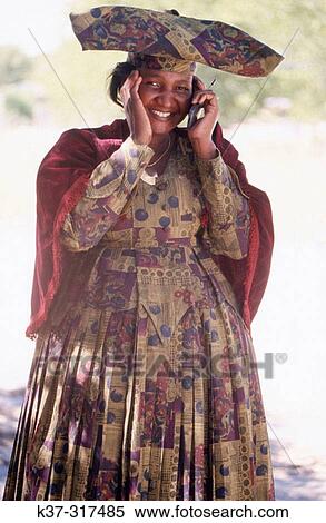 African woman in traditional clothes using cell phone View Large Photo Image Stock Photography - African woman in traditional clothes using cell phone. Fotosearch