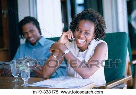 Afro-Amer. couple- girl on cellular View Large Photo Image Stock Photography - Afro-Amer. couple- girl on cellular. Fotosearch