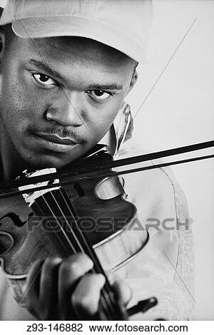 Stock Image - Afro-Amer man playing violin. Fotosearch