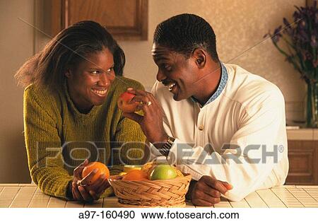 Afro-American couple in kitchen View Large Photo Image Stock Image - Afro-American couple in kitchen. Fotosearch