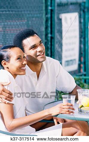 Afro American couple on vacation wearing tennis gear View Large Photo Image Picture - Afro American couple on vacation wearing tennis gear. Fotosearch