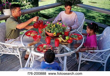 Afro-american family eating outdoors in deck View Large Photo Image Stock Photo - Afro-american family eating outdoors in deck. Fotosearch