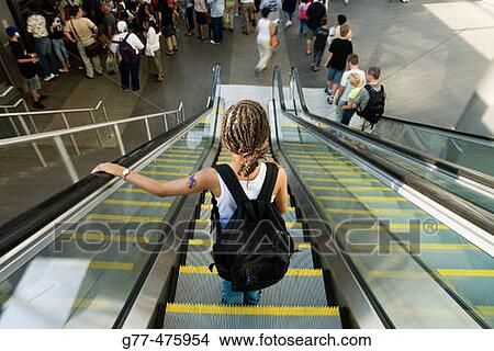 Afroamerican girl on escalator. New York. USA. View Large Photo Image Picture - Afroamerican girl on escalator. New York. USA.. Fotosearch