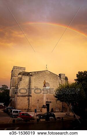 After a rainstorm a rainbow appears over the 13th century Church of St. Saturnin on the outskirts of Pezenas, France View Large Photo Image Stock Photo - After a rainstorm a rainbow appears over the 13th century Church of St. Saturnin on the outskirts of Pezenas, France. Fotosearch