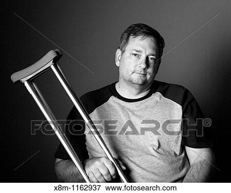 After surgery, a man with a surgically repaired broken leg with crutches View Large Photo Image Stock Photo - After surgery, a man with a surgically repaired broken leg with crutches. Fotosearch