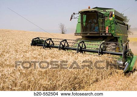 Agricultural machinery. Combine harvester on field of wheat.? Learza? estate. Near Estella, Navarre, Spain View Large Photo Image Picture - Agricultural machinery. Combine harvester on field of wheat.? Learza? estate. Near Estella, Navarre, Spain. Fotosearch