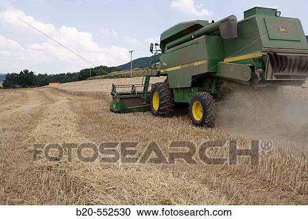 Agricultural machinery. Combine harvester on field of wheat.? Learza? estate. Near Estella, Navarre, Spain View Large Photo Image Stock Image - Agricultural machinery. Combine harvester on field of wheat.? Learza? estate. Near Estella, Navarre, Spain. Fotosearch