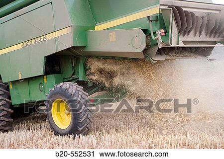 Agricultural machinery. Combine harvester on field of wheat.? Learza? estate. Near Estella, Navarre, Spain View Large Photo Image Stock Image - Agricultural machinery. Combine harvester on field of wheat.? Learza? estate. Near Estella, Navarre, Spain. Fotosearch