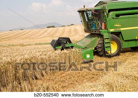 Stock Image - Agricultural machinery. Combine harvester on field of wheat.? Learza? estate. Near Estella, Navarre, Spain. Fotosearch