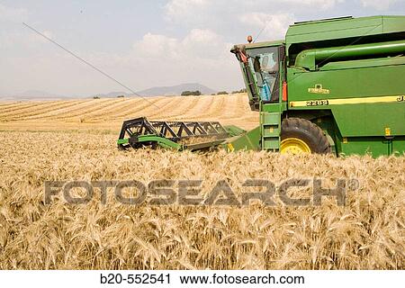 Agricultural machinery. Combine harvester on field of wheat.? Learza? estate. Near Estella, Navarre, Spain View Large Photo Image Stock Image - Agricultural machinery. Combine harvester on field of wheat.? Learza? estate. Near Estella, Navarre, Spain. Fotosearch