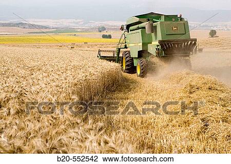 Agricultural machinery. Combine harvester on field of wheat.? Learza? estate. Near Estella, Navarre, Spain View Large Photo Image Stock Image - Agricultural machinery. Combine harvester on field of wheat.? Learza? estate. Near Estella, Navarre, Spain. Fotosearch