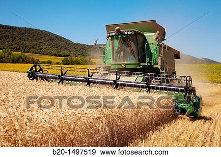 Agricultural machinery Combine harvester on field of wheat? Learza? estate Near Estella, Navarre, Spain View Large Photo Image Stock Photo - Agricultural machinery Combine harvester on field of wheat? Learza? estate Near Estella, Navarre, Spain. Fotosearch