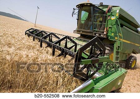 Agricultural machinery. Combine harvester on field of wheat.? Learza? estate. Near Estella, Navarre, Spain View Large Photo Image Stock Photo - Agricultural machinery. Combine harvester on field of wheat.? Learza? estate. Near Estella, Navarre, Spain. Fotosearch