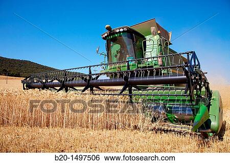 Agricultural machinery Combine harvester on field of wheat? Learza? estate Near Estella, Navarre, Spain View Large Photo Image Stock Photograph - Agricultural machinery Combine harvester on field of wheat? Learza? estate Near Estella, Navarre, Spain. Fotosearch